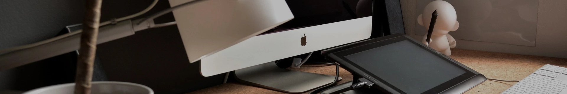 Office workspace with computer monitors, desk lamps, and desk accessories